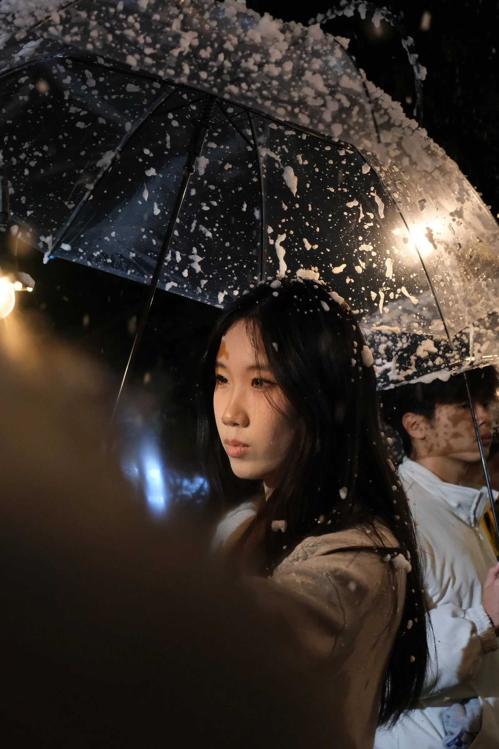 Portrait under a transparent umbrella at night